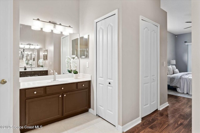2465 Tuscarora Ct, Melbourne, FL 32904 - bathroom with a closet, vanity, ensuite bath, and baseboards