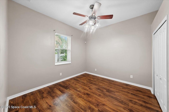 2465 Tuscarora Ct, Melbourne, FL 32904 - unfurnished bedroom featuring baseboards, a closet, dark wood-type flooring, and ceiling fan