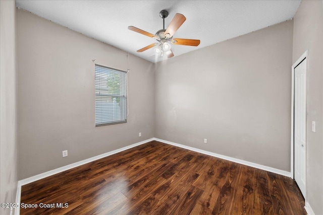 2465 Tuscarora Ct, Melbourne, FL 32904 - empty room featuring baseboards, dark wood-type flooring, and a ceiling fan