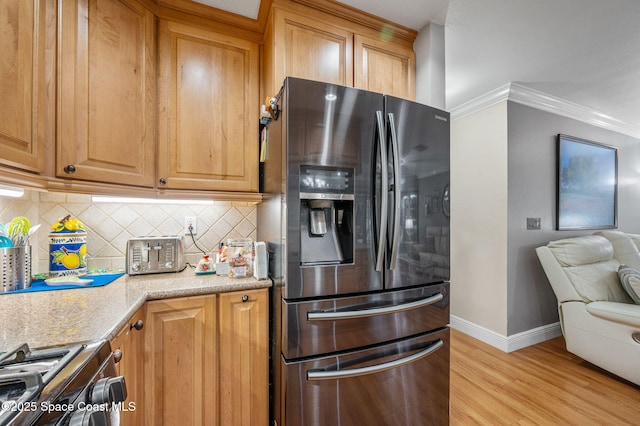 109 Plover Ln Unit 4-35, Rockledge, FL 32955 - kitchen with stainless steel refrigerator with ice dispenser, crown molding, decorative backsplash, baseboards, and light wood finished floors