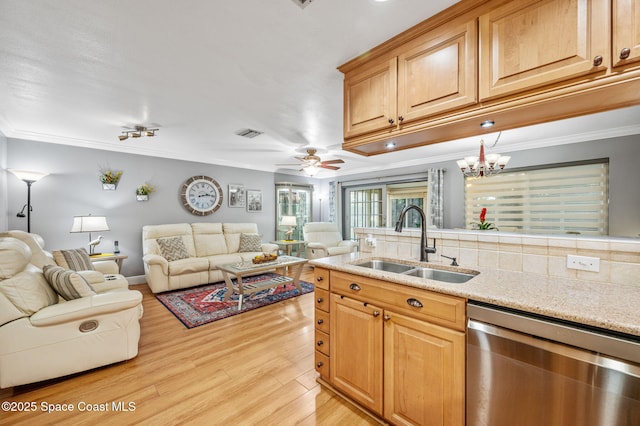 109 Plover Ln Unit 4-35, Rockledge, FL 32955 - kitchen featuring a sink, dishwasher, open floor plan, light wood-style floors, and light stone counters