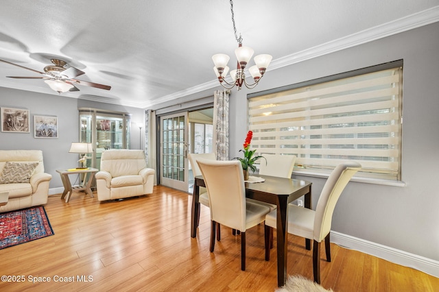109 Plover Ln Unit 4-35, Rockledge, FL 32955 - dining room featuring a chandelier, crown molding, baseboards, wood finished floors, and ceiling fan