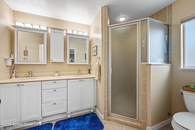 109 Plover Ln Unit 4-35, Rockledge, FL 32955 - bathroom with toilet, double vanity, a shower stall, tile patterned floors, and baseboards