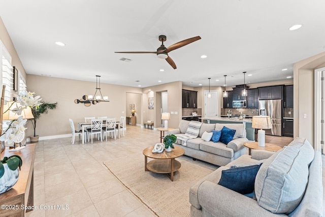 3387 Caviston Way, Melbourne, FL 32940 - living room featuring recessed lighting, light tile patterned floors, baseboards, a ceiling fan, and a chandelier
