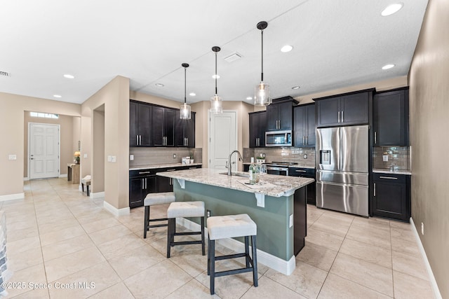 3387 Caviston Way, Melbourne, FL 32940 - kitchen featuring stainless steel appliances, backsplash, a sink, light tile patterned floors, and baseboards