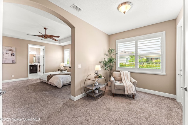 3387 Caviston Way, Melbourne, FL 32940 - carpeted bedroom featuring baseboards, arched walkways, ensuite bath, and ceiling fan