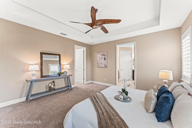 3387 Caviston Way, Melbourne, FL 32940 - bedroom featuring carpet, a tray ceiling, baseboards, and multiple windows