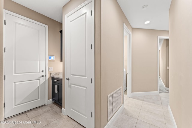 3387 Caviston Way, Melbourne, FL 32940 - hallway with light tile patterned floors and baseboards