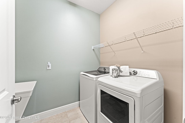 3387 Caviston Way, Melbourne, FL 32940 - laundry area featuring washer and dryer, baseboards, and light tile patterned floors