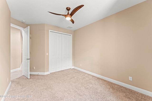 3387 Caviston Way, Melbourne, FL 32940 - unfurnished bedroom with carpet, a closet, baseboards, and a ceiling fan