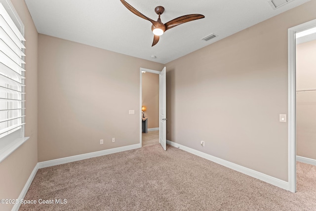3387 Caviston Way, Melbourne, FL 32940 - unfurnished bedroom with carpet flooring, baseboards, a spacious closet, and a ceiling fan