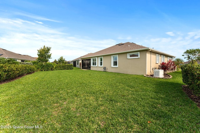 3387 Caviston Way, Melbourne, FL 32940 - back of house featuring stucco siding, a lawn, and central AC unit
