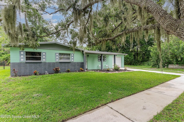 2109 Ivy Dr, Cocoa, FL 32922 - mid-century inspired home with an attached garage, a front lawn, and driveway
