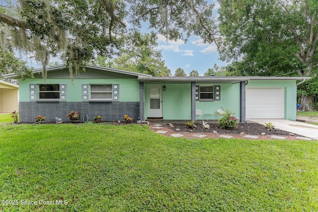 2109 Ivy Dr, Cocoa, FL 32922 - view of front of house featuring a garage, driveway, and a front lawn