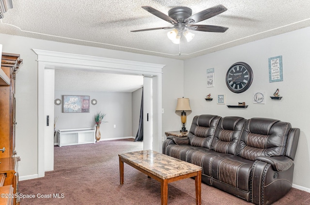 2109 Ivy Dr, Cocoa, FL 32922 - carpeted living room with a ceiling fan, baseboards, and a textured ceiling