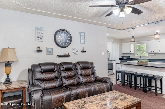 2109 Ivy Dr, Cocoa, FL 32922 - living area featuring a ceiling fan, a textured ceiling, and light carpet