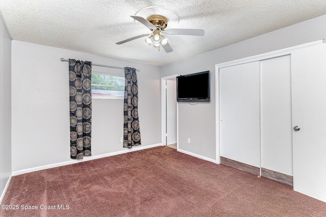 2109 Ivy Dr, Cocoa, FL 32922 - unfurnished bedroom featuring a textured ceiling, carpet floors, a closet, a ceiling fan, and baseboards