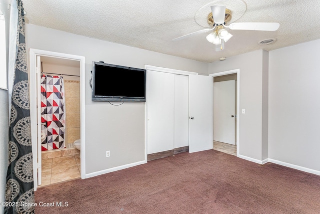 2109 Ivy Dr, Cocoa, FL 32922 - unfurnished bedroom featuring carpet flooring, a textured ceiling, ensuite bathroom, a closet, and a ceiling fan
