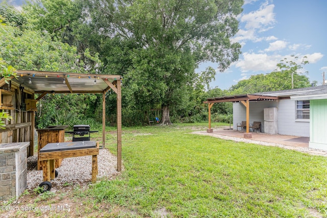 2109 Ivy Dr, Cocoa, FL 32922 - view of green lawn with a patio and a pergola