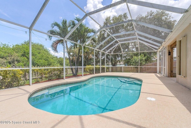 4843 Erin Ln, Melbourne, FL 32940 - outdoor pool with a fenced backyard, glass enclosure, and a patio area