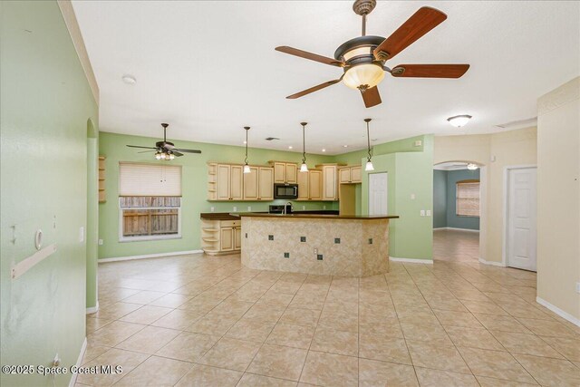 4843 Erin Ln, Melbourne, FL 32940 - kitchen featuring black microwave, a ceiling fan, arched walkways, dark countertops, and baseboards