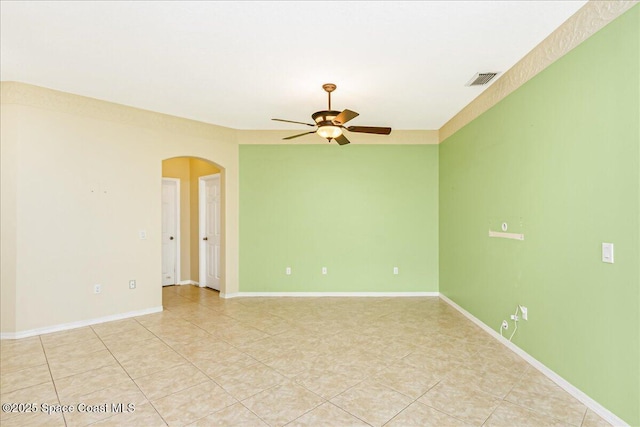 4843 Erin Ln, Melbourne, FL 32940 - spare room with arched walkways, ceiling fan, light tile patterned flooring, and baseboards