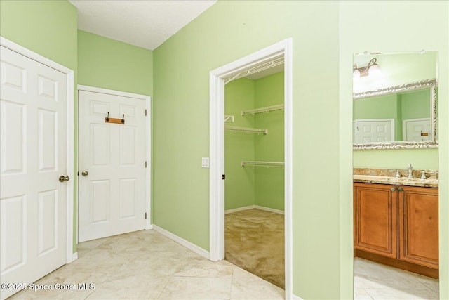 4843 Erin Ln, Melbourne, FL 32940 - corridor featuring a sink and baseboards