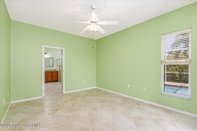 4843 Erin Ln, Melbourne, FL 32940 - empty room with a ceiling fan, baseboards, and light tile patterned floors