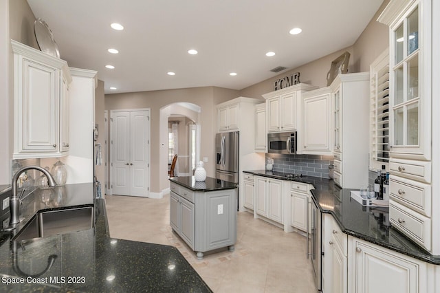 5145 Limousin Ct, Rockledge, FL 32955 - kitchen with stainless steel appliances, a sink, arched walkways, recessed lighting, and tasteful backsplash
