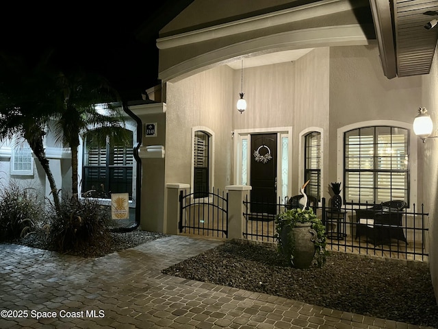 5145 Limousin Ct, Rockledge, FL 32955 - view of exterior entry with stucco siding and a gate