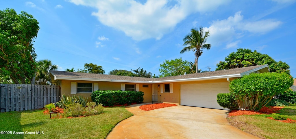 1104 Sioux Dr, Indian Harbour Beach, FL 32937 - ranch-style house featuring a garage, stucco siding, and driveway