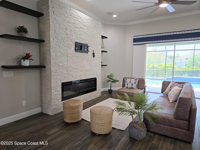 7690 Kerrington Dr, Melbourne, FL 32940 - living area featuring ceiling fan, dark wood-type flooring, a fireplace, ornamental molding, and recessed lighting
