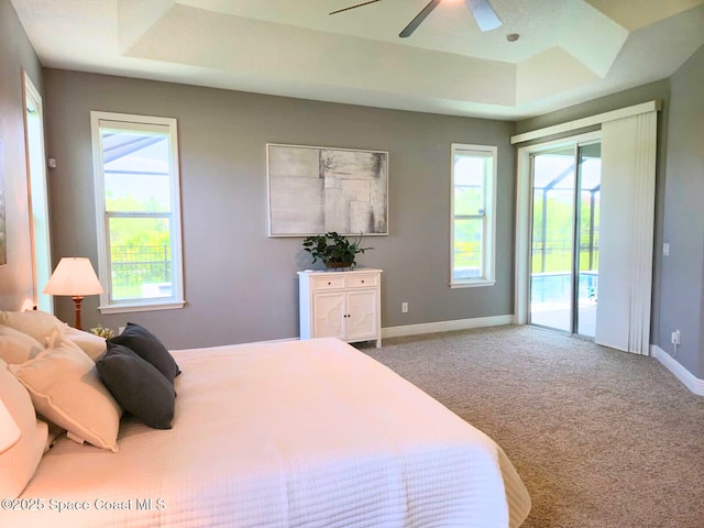 7690 Kerrington Dr, Melbourne, FL 32940 - bedroom with a raised ceiling, access to outside, carpet, and multiple windows