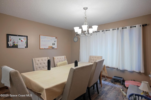 1387 Gleneagles Ct, Rockledge, FL 32955 - dining room with a chandelier, dark wood-style floors, and a textured ceiling