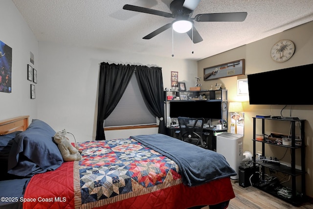1387 Gleneagles Ct, Rockledge, FL 32955 - bedroom with wood finished floors, a textured ceiling, and a ceiling fan