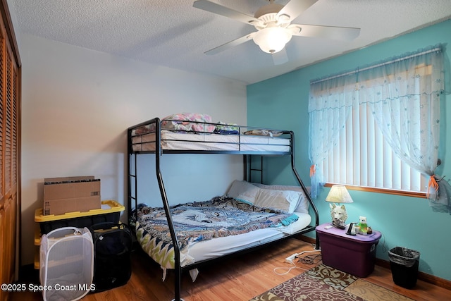 1387 Gleneagles Ct, Rockledge, FL 32955 - bedroom with wood finished floors, a ceiling fan, and a textured ceiling