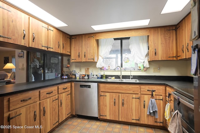 1387 Gleneagles Ct, Rockledge, FL 32955 - kitchen featuring appliances with stainless steel finishes, a sink, dark countertops, tile patterned floors, and brown cabinetry