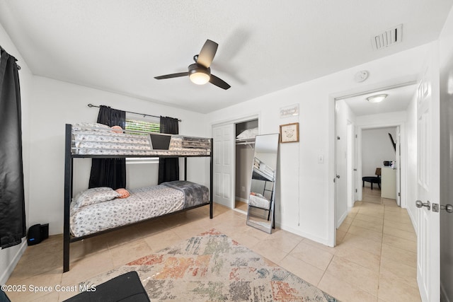 1941 Dawn Dr, Melbourne, FL 32935 - bedroom featuring light tile patterned flooring, a closet, a ceiling fan, and baseboards