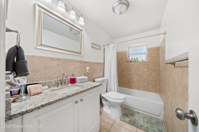 1941 Dawn Dr, Melbourne, FL 32935 - full bathroom featuring tile walls, tile patterned floors, vanity, toilet, and shower / tub combo with curtain