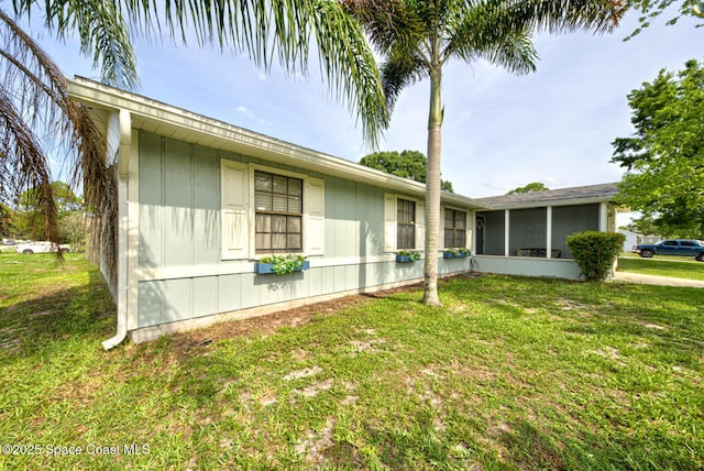 581 Howe Ave SE, Palm Bay, FL 32909 - view of side of property featuring a sunroom and a yard
