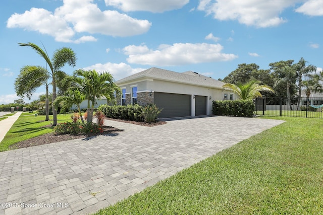 1025 Aranceto Cir, Merritt Island, FL 32952 - view of front of home with decorative driveway, a garage, and stucco siding
