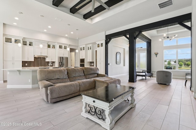 1025 Aranceto Cir, Merritt Island, FL 32952 - living room featuring light wood-style floors, recessed lighting, a chandelier, and a raised ceiling