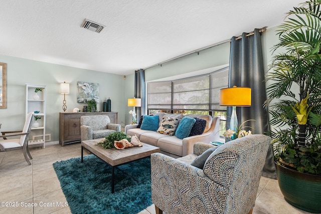 715 Atlantic Dr, Satellite Beach, FL 32937 - living room featuring light tile patterned floors and a textured ceiling