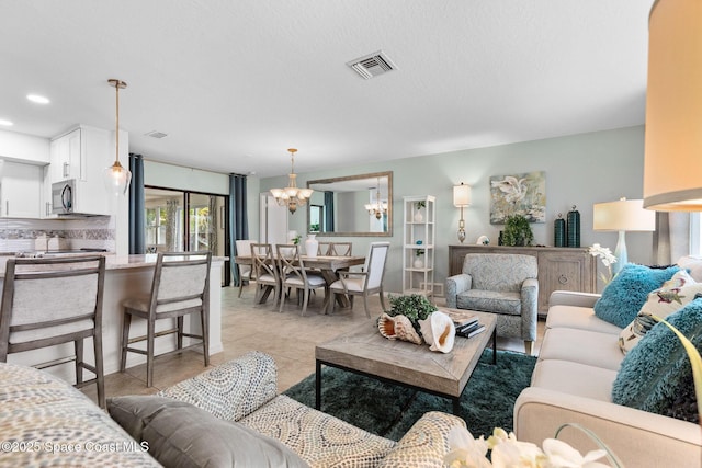 715 Atlantic Dr, Satellite Beach, FL 32937 - living room with a chandelier, light tile patterned floors, and recessed lighting