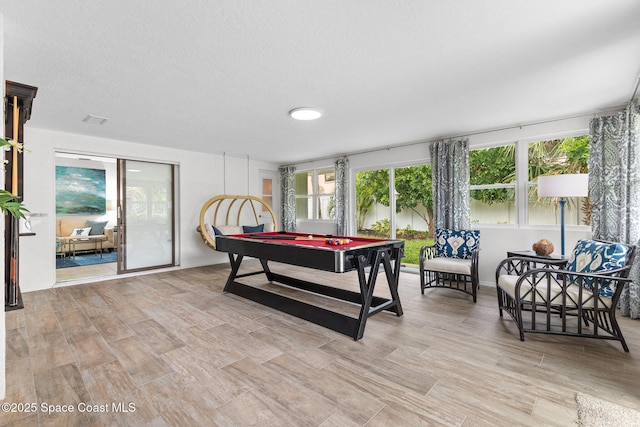 715 Atlantic Dr, Satellite Beach, FL 32937 - game room featuring light wood finished floors and a textured ceiling