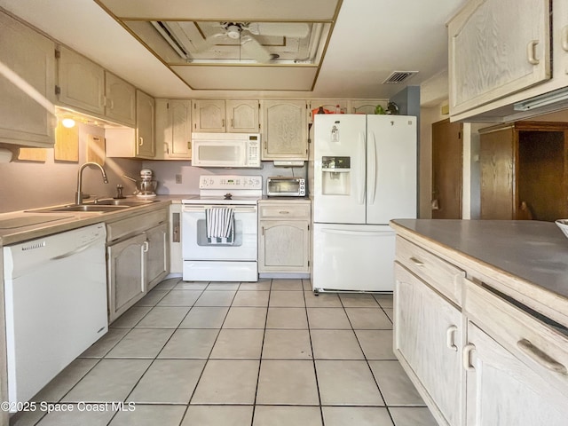 1395 Angler St, Merritt Island, FL 32952 - kitchen featuring white appliances, a sink, light tile patterned floors, and light countertops