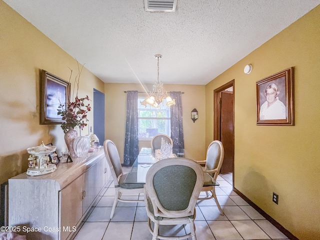1395 Angler St, Merritt Island, FL 32952 - dining room with a chandelier, light tile patterned flooring, a textured ceiling, and baseboards