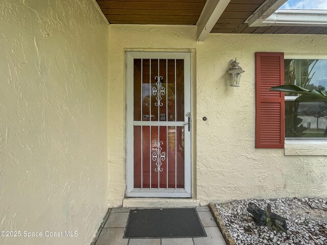 1395 Angler St, Merritt Island, FL 32952 - doorway to property featuring stucco siding