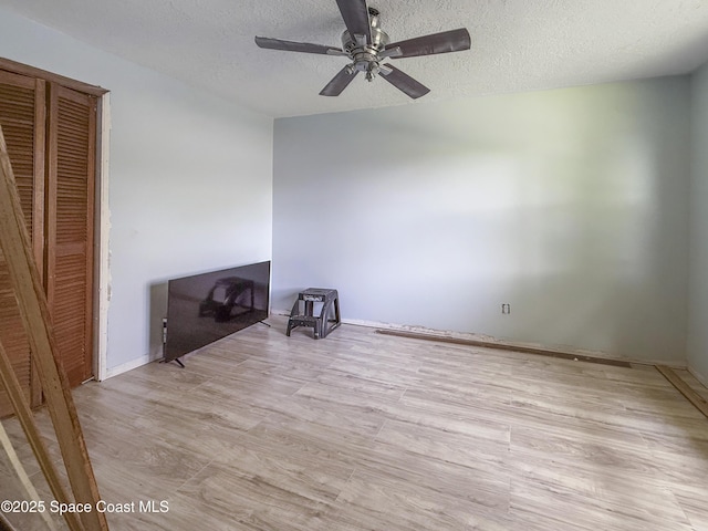 1395 Angler St, Merritt Island, FL 32952 - unfurnished bedroom featuring a textured ceiling, light wood-type flooring, and ceiling fan