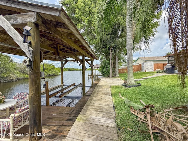 1395 Angler St, Merritt Island, FL 32952 - dock area with boat lift, a yard, and a water view